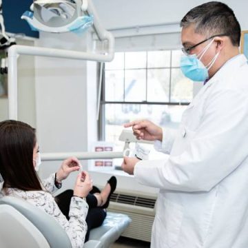Dr. Jason Arandia, DMD with patient at Sharon Dental Group